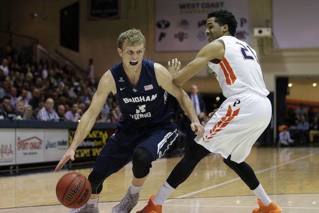 BYU's Tyler Haws, left, drives past Pepperdine's Shawn Olden during the first half of an NCAA college basketball game Thursday, Feb. 5, 2015, in Malibu, Calif. (AP Photo/Jae C. Hong)