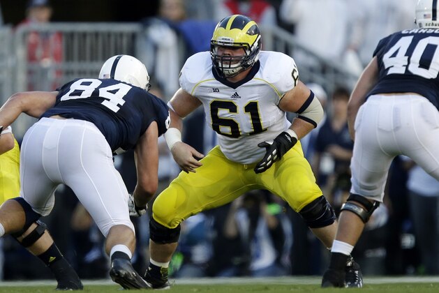 Michigan offensive linesman Graham Glasgow (61) blocks during the second quarter of an NCAA college football game against Penn State in State College, Pa., Saturday, Oct. 12, 2013. Penn State won 43-40 in the fourth overtime. (AP Photo/Gene J. Puskar)