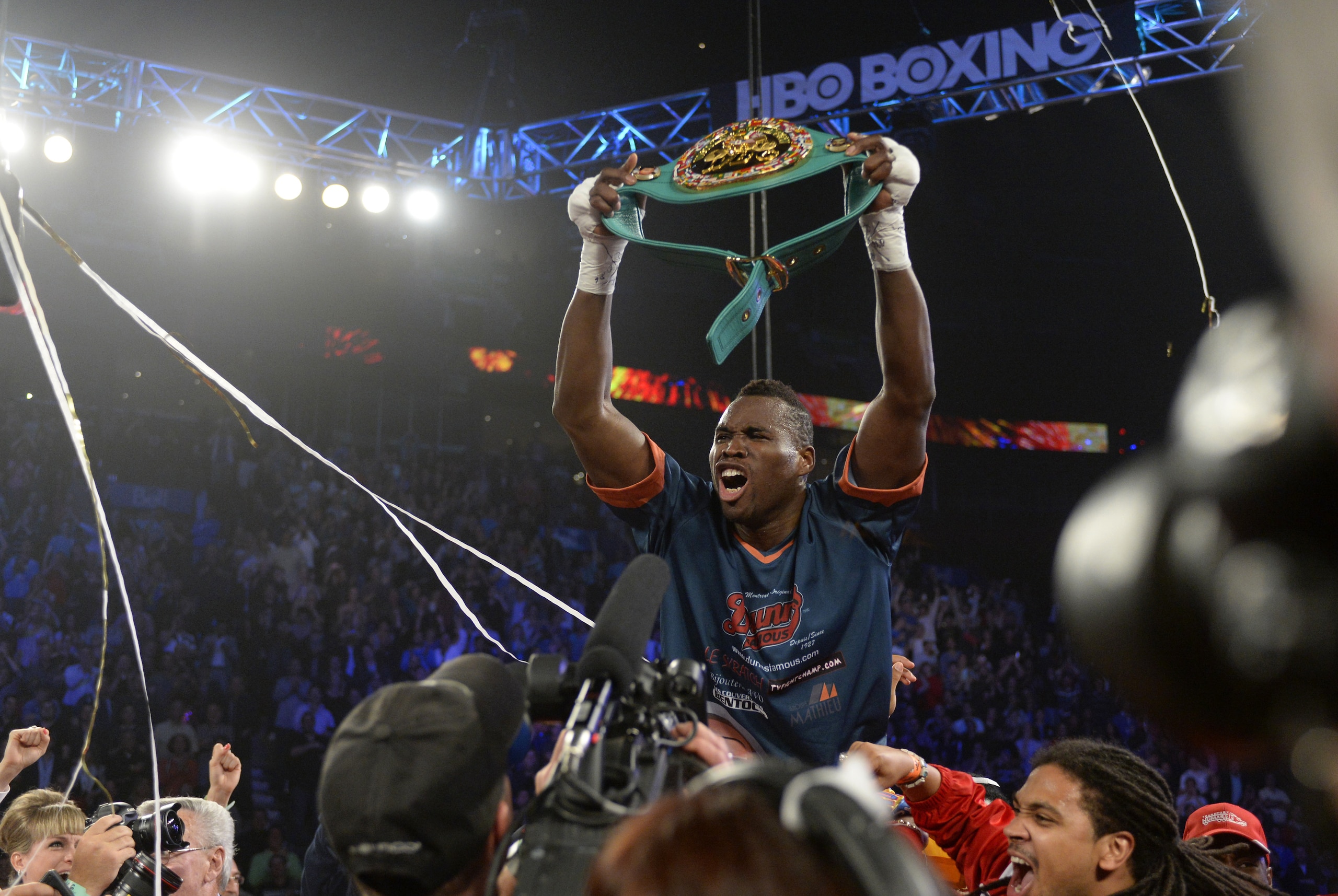 Jun 8, 2013; Montreal, Quebec, Canada; Adonis Stevenson (gold/yellow) celebrates with the belt after knocking out Chad Dawson (not pictured) during the first round of their light heavyweight WBC title bout at the Bell Centre. Mandatory Credit: Eric Bolte-USA TODAY Sports Jun 8, 2013; Montreal, Quebec, Canada; Adonis Stevenson (gold/yellow) celebrates with the belt after knocking out Chad Dawson (not pictured) during the first round of their light heavyweight WBC title bout at the Bell Centre. Mandatory Credit: Eric Bolte-USA TODAY Sports