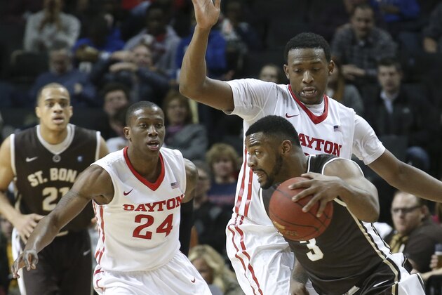 St. Bonaventure guard Marcus Posley (3) looks for an opening against Dayton forward Kendall Pollard, center, as guard Jordan Sibert (24) watches during the second half of an NCAA college basketball game in the quarterfinals of the Atlantic 10 Conference tournament at the Barclays Center in New York, Friday, March 13, 2015. Dayton won 75-71. (AP Photo/John Minchillo)