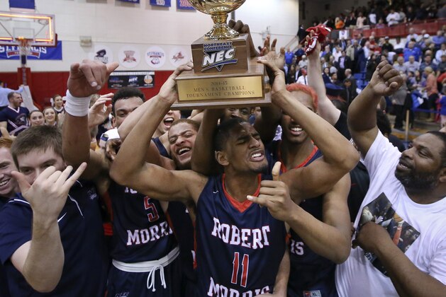 Robert Morris guard Rodney Pryor (11) raises their trophy after winning an NCAA college basketball game against St. Francis in the championship of the Northeast Conference tournament, Tuesday, March 10, 2015, in New York. Roger Morris won, 66-63. (AP Photo/John Minchillo)