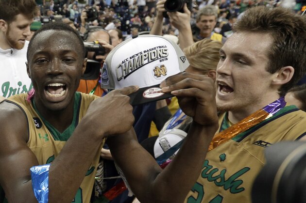 Notre Dame's Jerian Grant, left, and Pat Connaughton (24) celebrate after an NCAA college basketball game against North Carolina in the championship of the Atlantic Coast Conference tournament Saturday, March 14, 2015, in Greensboro, N.C. Notre Dame won 90-82. (AP Photo/Gerry Broome)