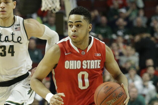 Ohio State's D'Angelo Russell (0) drives in front of Michigan State's Gavin Schilling (34) and Denzel Valentine (45) in the second half of an NCAA college basketball game in the quarterfinals of the Big Ten Conference tournament in Chicago, Friday, March 13, 2015. (AP Photo/Nam Y. Huh)