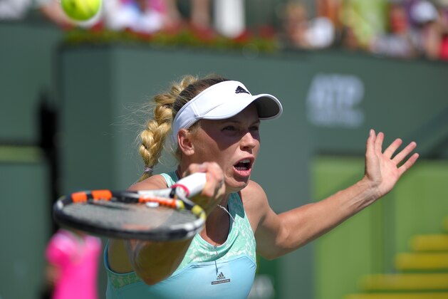 Caroline Wozniacki, of Denmark, returns a volley against Belinda Bencic, of Switzerland, during their match at the BNP Paribas Open tennis tournament, Monday, March 16, 2015 in Indian Wells, Calif. (AP Photo/Mark J. Terrill)