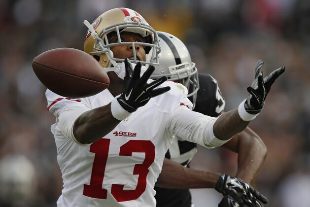 OAKLAND, CA - DECEMBER 7:  Wide receiver Stevie Johnson #13 of the San Francisco 49ers tries unsuccessfully to pull down a pass against cornerback Chimdi Chekwa #35 of the Oakland Raiders in the second quarter on December 7, 2014 at O.co Coliseum in Oakland, California.  The Raiders won 24-13.  (Photo by Brian Bahr/Getty Images)