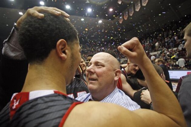 Eastern Washington Head Coach Jim Hayford hugs senior guard and leading scorer in the nation Tyler Harvey (1) after defeating Montana during an NCAA college basketball championship game in the Championship of Big Sky Conference tournament in Missoula, Mont., Saturday, March 14, 2015. (AP Photos/Michael Albans)