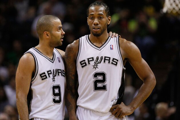 Mar 26, 2014; San Antonio, TX, USA; San Antonio Spurs guard Tony Parker (9) talks with Kawhi Leonard (2) during the second half against the Denver Nuggets at AT&T Center. Mandatory Credit: Soobum Im-USA TODAY Sports