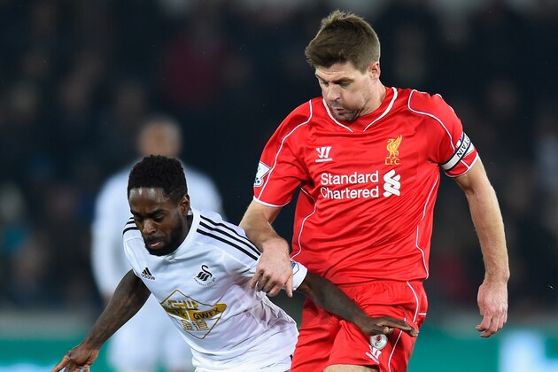 SWANSEA, WALES - MARCH 16:  Liverpool player Steven Gerrard (r) challenges Nathan Dyer of Swansea during the Barclays Premiership match between Swansea City and Liverpool at Liberty Stadium on March 16, 2015 in Swansea, Wales.  (Photo by Stu Forster/Getty Images)