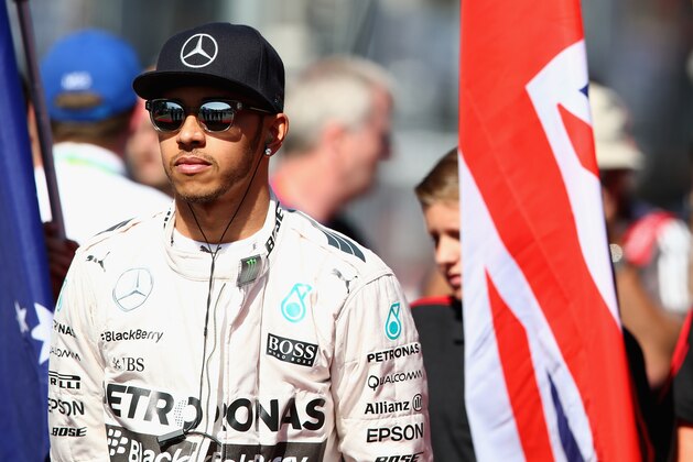 MELBOURNE, AUSTRALIA - MARCH 15:  Lewis Hamilton of Great Britain and Mercedes GP stands on the grid for the national anthem before  the Australian Formula One Grand Prix at Albert Park on March 15, 2015 in Melbourne, Australia.  (Photo by Mark Thompson/Getty Images)