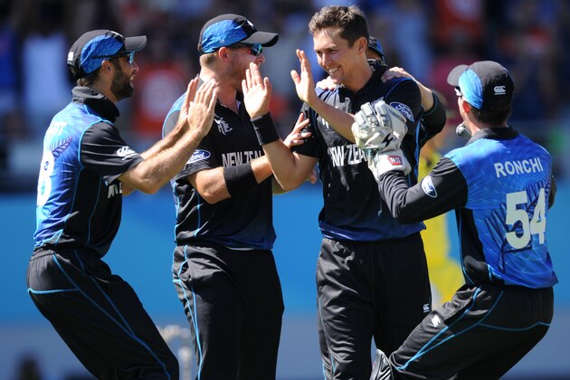 New Zealand’s Trent Boult, second right, is congratulated by his teammates after taking the wicket of Australia's Mitchell Marsh during their Cricket World Cup match in Auckland, New Zealand, Saturday, Feb. 28, 2015. (AP Photo Ross Setford)