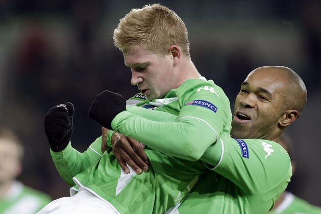 Wolfsburg's scorer Kevin De Bruyne, left, and his teammate Naldo celebrate their side's third goal during the Europa League round of sixteen first leg soccer match between VfL Wolfsburg and FC Internazionale Milano in Wolfsburg, Germany, Thursday, March 12, 2015. (AP Photo/Michael Sohn)