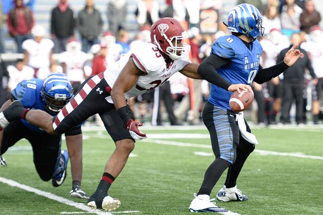 Nov 30, 2013; Memphis, TN, USA; Temple Owls linebacker Haason Reddick (33) tries to bring down Memphis Tigers quarterback Jacob Karam (9) during the second half at Liberty Bowl Memorial. Temple Owls beat the Memphis Tigers 41-21. Mandatory Credit: Justin Ford-USA TODAY Sports