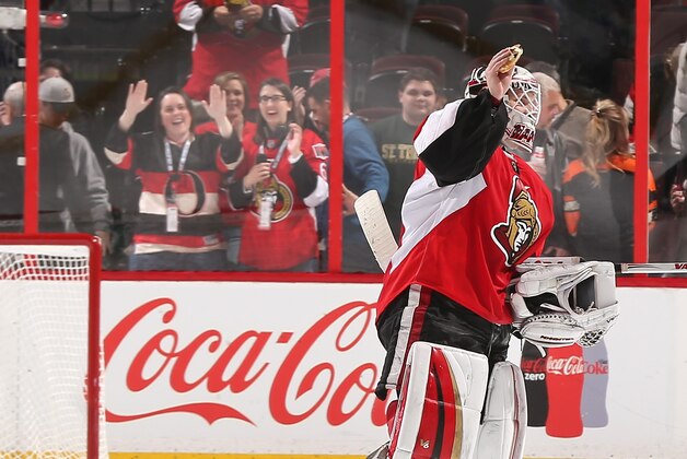 OTTAWA, ON - MARCH 15: Andrew Hammond #30 of the Ottawa Senators holds up a hamburger thrown onto the ice after his shootout win over the Philadelphia Flyers at Canadian Tire Centre on March 15, 2015 in Ottawa, Ontario, Canada.  (Photo by Andre Ringuette/NHLI via Getty Images)