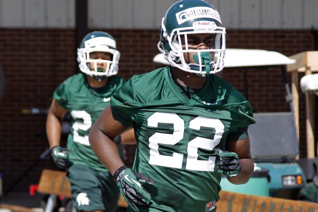 Michigan State running backs Delton Williams (22) and Gerald Holmes run to position during Michigan State's first preseason NCAA college football practice, Saturday, Aug. 3, 2013, in East Lansing, Mich. (AP Photo/Al Goldis)