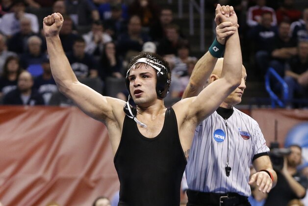 Iowa's Tony Ramos celebrates after defeating Edinboro's Aaron Schopp in a 133-pound match in the semifinals of the NCAA Division I wrestling championships in Oklahoma City, Friday, March 21, 2014. (AP Photo/Sue Ogrocki)