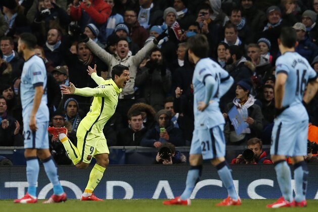 Barcelona's Luis Suarez, second left, celebrates after scoring the opening goal of his team during the Champions League Round of 16 soccer match between Manchester City and Barcelona at Etihad Stadium in Manchester, England, Tuesday, Feb. 24, 2015. (AP Photo/Jon Super)