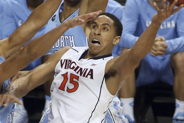 Virginia's Malcolm Brogdon (15) shoots against North Carolina's Brice Johnson, left, during the first half of an NCAA college basketball game in the semifinals of the Atlantic Coast Conference tournament in Greensboro, N.C., Friday, March 13, 2015. (AP Photo/Bob Jordan)