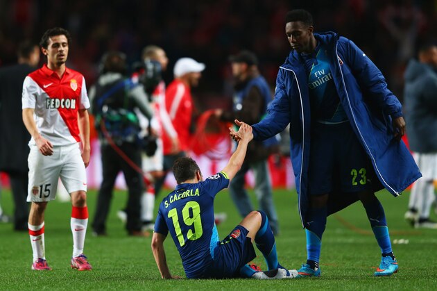 MONACO - MARCH 17:  Danny Welbeck of Arsenal consoles team mate Santi Cazorla (19) as they eliminated after the UEFA Champions League round of 16 second leg match between AS Monaco and Arsenal at Stade Louis II on March 17, 2015 in Monaco, Monaco. Arsenal won the match 2-0, but lost on the away goals rule. (Photo by Michael Steele/Getty Images)