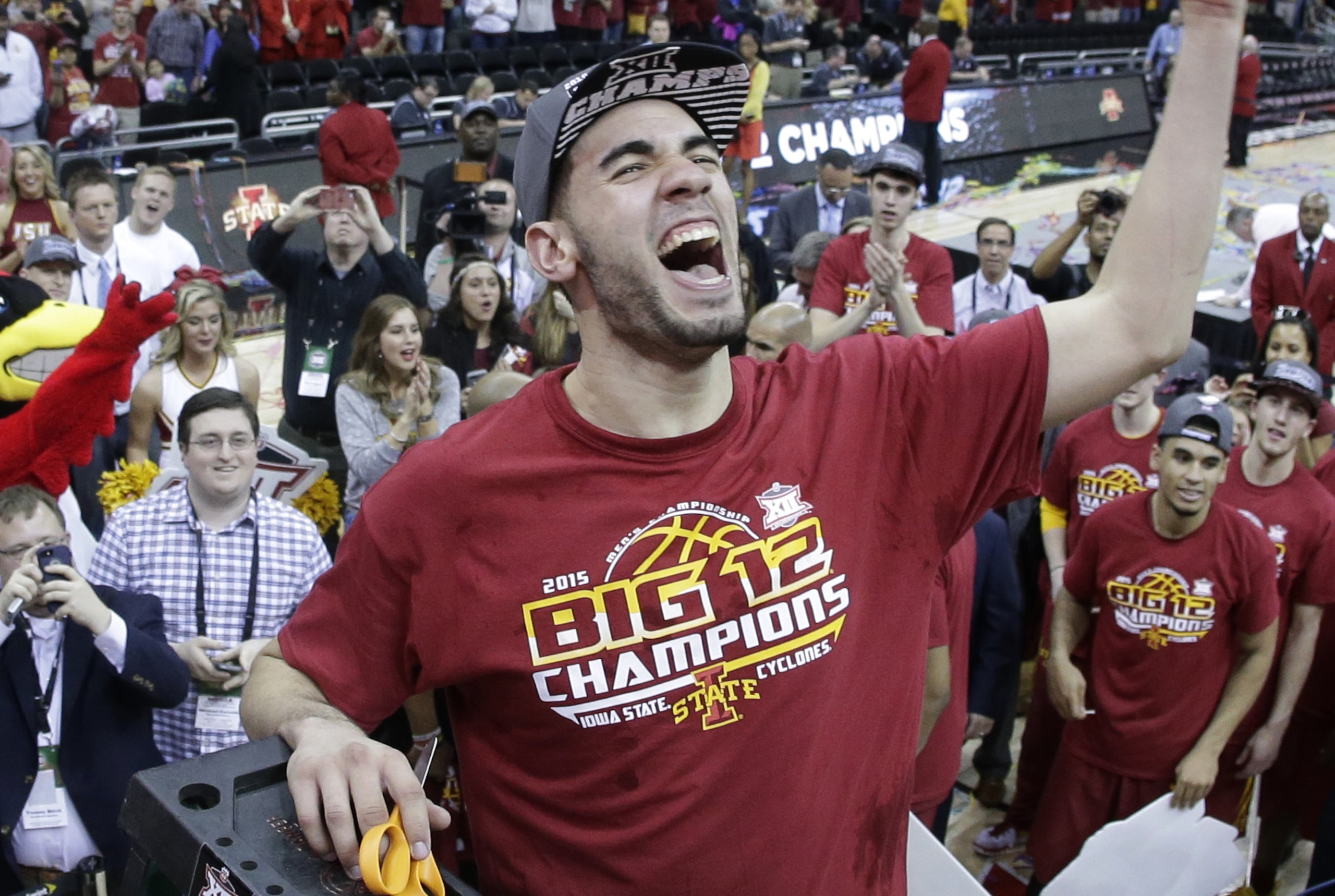 Iowa State's Georges Niang  cuts down the net after winning an NCAA college basketball game against Kansas in the finals of the Big 12 Conference tournament Saturday, March 14, 2015, in Kansas City, Mo. Iowa State won 70-66. (AP Photo/Charlie Riedel)