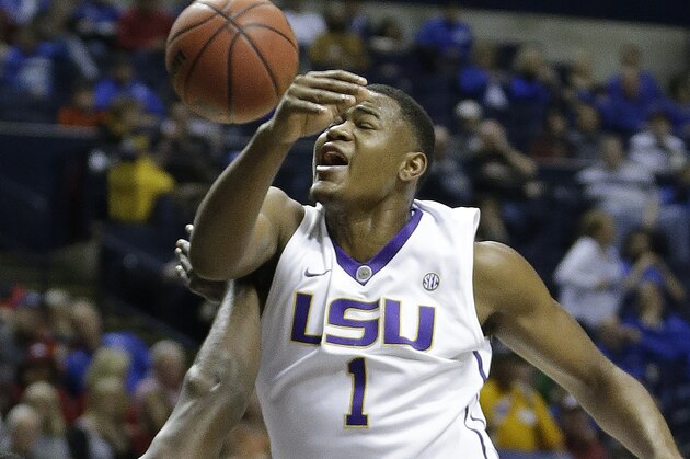 LSU forward Jarell Martin (1) collides with Auburn guard KT Harrell (1) as Martin shoots during the first half of an NCAA college basketball game in the quarter final round of the Southeastern Conference tournament, Friday, March 13, 2015, in Nashville, Tenn. (AP Photo/Mark Humphrey)