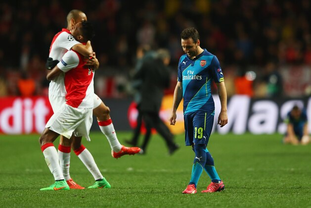 MONACO - MARCH 17:  Santi Cazorla of Arsenal looks dejected as Monaco players celebrate qualifying for the next round after the UEFA Champions League round of 16 second leg match between AS Monaco and Arsenal at Stade Louis II on March 17, 2015 in Monaco, Monaco.  (Photo by Michael Steele/Getty Images)
