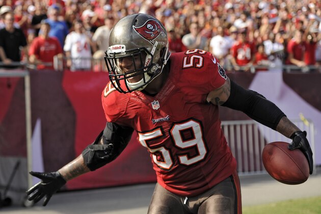 Tampa Bay Buccaneers middle linebacker Mason Foster (59) celebrates after his interception for a touchdown during the second quarter of an NFL football game against the Atlanta Falcons Sunday, Nov. 17, 2013, in Tampa, Fla. (AP Photo/Brian Blanco)