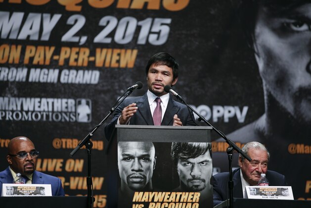 Boxer Manny Pacquiao, center, of the Philippines, speaks as he is joined by promoters, Bob Arum, right, and Leonard Ellerbe at a news conference, Wednesday, March 11, 2015, in Los Angeles. Pacquiao is scheduled to fight Floyd Mayweather Jr. in Las Vegas on May 2. (AP Photo/Jae C. Hong)