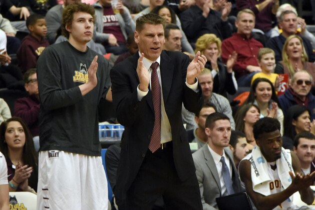 Loyola of Chicago head coach Porter Moser, center, reacts to a play against Wichita State during the first half of an NCAA college basketball game in Chicago, Sunday, Jan. 11, 2015. (AP Photo/David Banks)