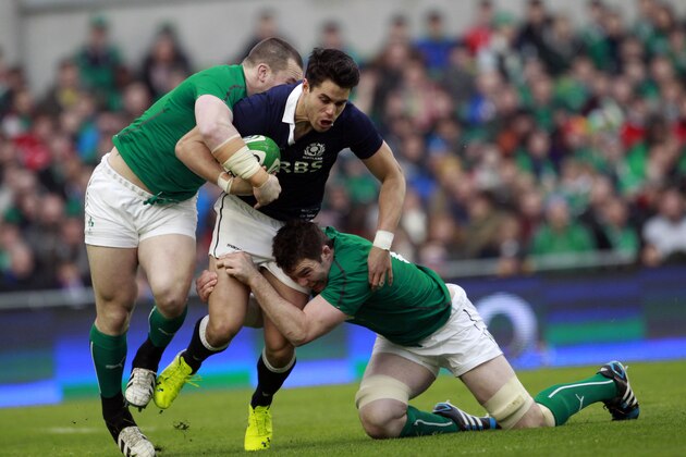 Scotland's Sean Maitland, centre, is tackled by Ireland's Cian Healy, left, and Peter O'Mahony during their Six Nations Rugby Union international match at the Aviva Stadium, Dublin, Ireland, Sunday, Feb. 2, 2014.  (AP Photo/Peter Morrison)