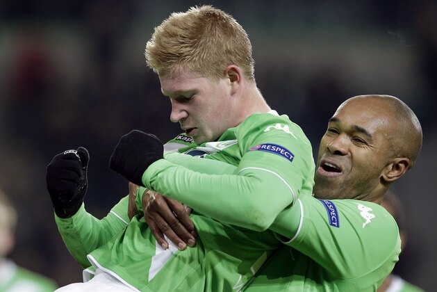 Wolfsburg's scorer Kevin De Bruyne, left, and his teammate Naldo celebrate their side's third goal during the Europa League round of sixteen first leg soccer match between VfL Wolfsburg and FC Internazionale Milano in Wolfsburg, Germany, Thursday, March 12, 2015. (AP Photo/Michael Sohn)