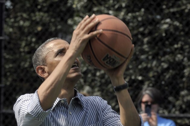 President Barack Obama shoots a basketball during the annual Easter Egg Roll on the South Lawn of the White House in Washington, Monday, April 1, 2013. (AP Photo/Susan Walsh)