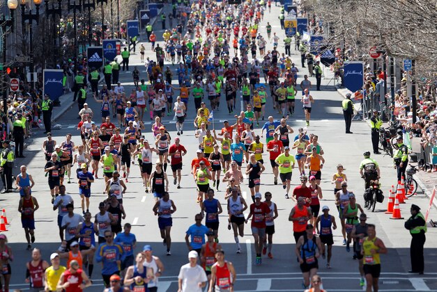 Apr 21, 2014; Boston, MA, USA; Runners stream down Boylston Street towards the finish line during the 2014 Boston Marathon. Mandatory Credit: Greg M. Cooper-USA TODAY Sports