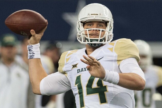 Nov 29, 2014; Arlington, TX, USA; Baylor Bears quarterback Bryce Petty (14) passes against the Texas Tech Red Raiders during the second half at AT&T Stadium. Petty leaves with an injury. The Bears defeated the Red Raiders 48-46. Mandatory Credit: Jerome Miron-USA TODAY Sports