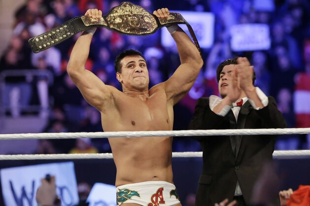 Jose Alberto Rodríguez, of Mexico, known as Alberto Del Rio holds up a championship belt after defeating Jacob