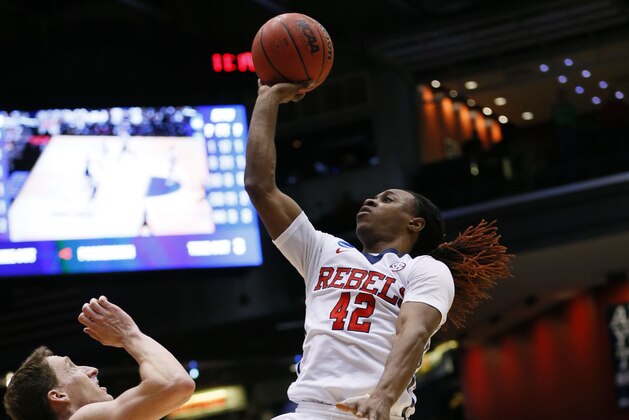 Mar 17, 2015; Dayton, OH, USA; Mississippi Rebels guard Stefan Moody (42) shoots while guarded by Brigham Young Cougars guard Skyler Halford (23) during the second half in the first round of the 2015 NCAA Tournament at UD Arena. Mandatory Credit: Rick Osentoski-USA TODAY Sports