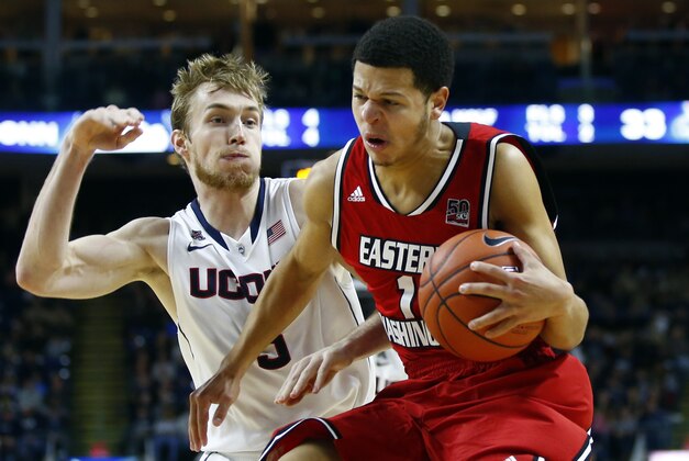 Dec 28, 2013; Bridgeport, CT, USA; Connecticut Huskies guard/forward Niels Giffey (5) defends against Eastern Washington Eagles guard Tyler Harvey (1) during the second half at Webster Bank Arena. UConn defeated Eastern Washington 82-65. Mandatory Credit: David Butler II-USA TODAY Sports
