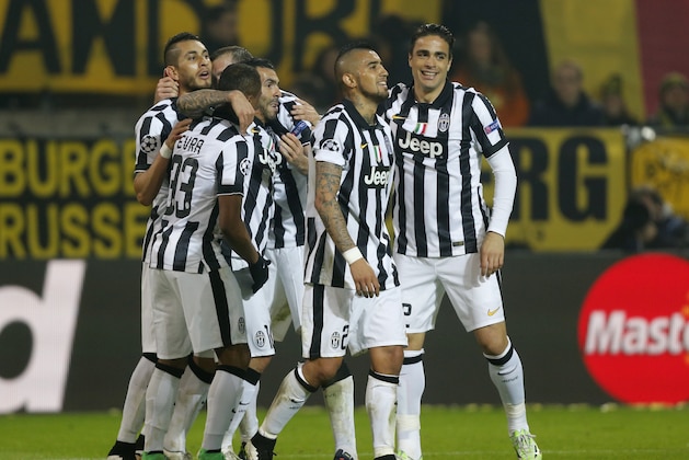 Juventus players celebrate their third goal during the Champions League round of 16 second leg soccer match between Borussia Dortmund and Juventus Turin on Wednesday, March 18, 2015 in Dortmund, Germany. (AP Photo/Frank Augstein)