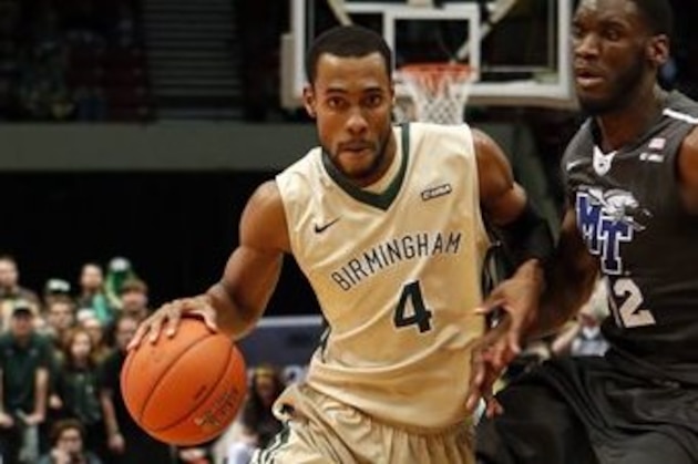 UAB guard Robert Brown (4) drives around Middle Tennessee forward Jacquez Rozier (42) while going to the basket during the first half of an NCAA college basketball game in the Conference USA tournament championship, Saturday, March 14, 2015, in Birmingham, Ala. (AP Photo/Butch Dill)