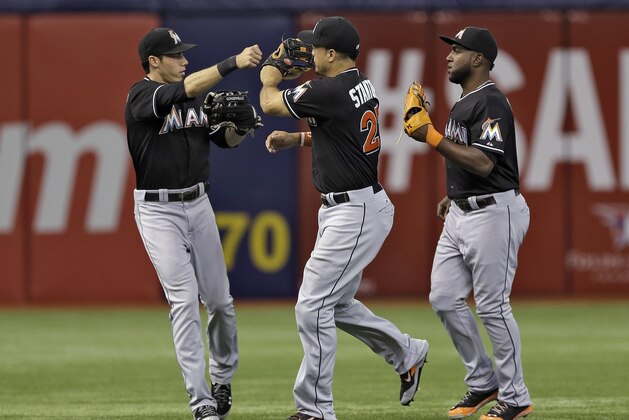Miami Marlins outfielders, from left, Christian Yelich, Giancarlo Stanton, and Marcell Ozuna celebrate after the team defeated the Tampa Bay Rays 11-6 during an interleague baseball game Thursday, June 5, 2014, in St. Petersburg, Fla. (AP Photo/Chris O'Meara) Miami Marlins outfielders, from left, Christian Yelich, Giancarlo Stanton, and Marcell Ozuna celebrate after the team defeated the Tampa Bay Rays 11-6 during an interleague baseball game Thursday, June 5, 2014, in St. Petersburg, Fla. (AP Photo/Chris O'Meara)