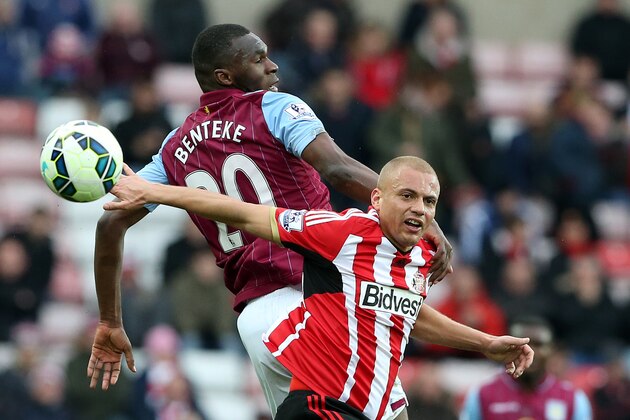 Sunderland's Wes Brown, right, vies for the ball with Aston Villa's Christian Benteke, left, during their English Premier League soccer match between Sunderland and Aston Villa  at the Stadium of Light, Sunderland, England, Saturday, March, 14, 2015. (AP Photo/Scott Heppell)