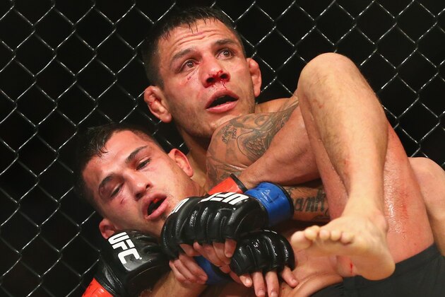 DALLAS, TX - MARCH 14:  Rafael dos Anjos, top fights with Anthony Pettis in the Lightweight Title bout during the UFC 185 event at American Airlines Center on March 14, 2015 in Dallas, Texas.  (Photo by Ronald Martinez/Getty Images)
