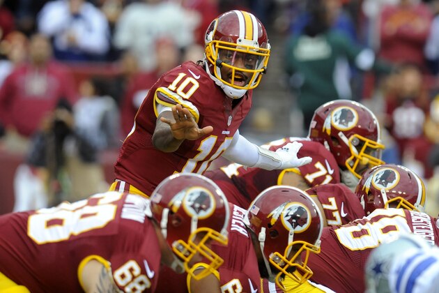 Washington Redskins quarterback Robert Griffin III (10) yells to the front line during the first half of an NFL football game against the Dallas Cowboys in Landover, Md., Sunday, Dec. 28, 2014. (AP Photo/Richard Lipski)