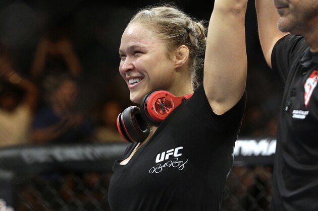 Ronda Rousey celebrates after defeating Alexis Davis in their women's mixed martial arts bantamweight title bout at UFC 175 on Saturday, July 5, 2014, in Las Vegas. (AP Photo/John Locher)