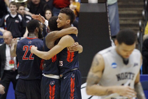 Robert Morris players celebrate after an 81-77 win over North Florida in a first round NCAA tournament basketball game Wednesday, March 18, 2015, in Dayton, Ohio. (AP Photo/Skip Peterson)