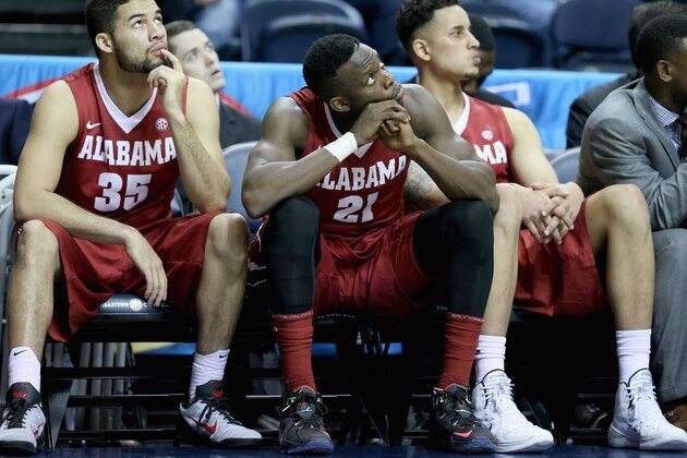 NASHVILLE, TN - MARCH 12:  Dakota Slaughter #35 and Rodney Cooper #21 of the Alabama Crimson Tide watch the final seconds of the 69-61 loss to the Florida Gators in the second round game of the SEC Basketball Tournament at Bridgestone Arena on March 12, 2015 in Nashville, Tennessee.  (Photo by Andy Lyons/Getty Images)