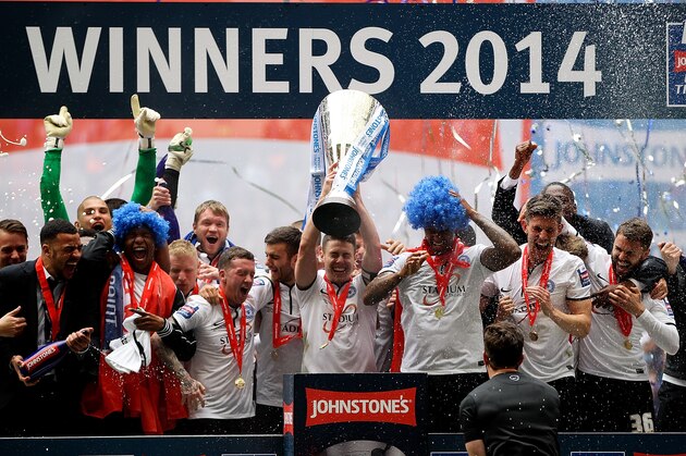 LONDON, ENGLAND - MARCH 30: Peterborough captain Tommy Rowe lifts the trophy after his team won the Johnstone's Paint Trophy Final between Chesterfield and Peterborough United at Wembley Stadium on March 30, 2014 in London, England.  (Photo by Ben Hoskins/Getty Images)
