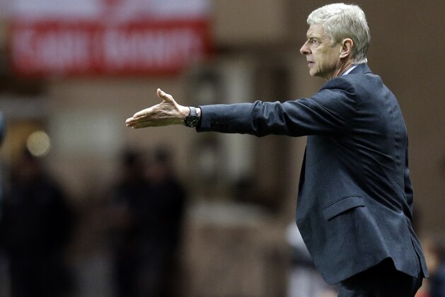 Arsenal manager Arsene Wenger, right, gestures to his players during the Champions League round of 16 second leg soccer match between Monaco and Arsenal at Louis II stadium in Monaco, Tuesday, March 17, 2015. (AP Photo/Lionel Cironneau)