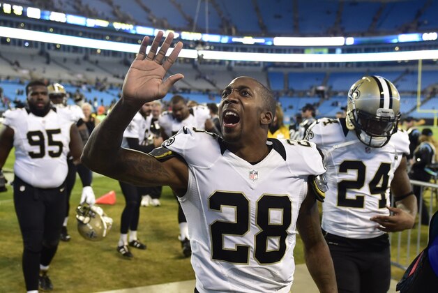 Oct 30, 2014; Charlotte, NC, USA; New Orleans Saints cornerback Keenan Lewis (28) and defensive end Brandon Deaderick (95) and cornerback Corey White (24) leave the field after the game. The Saints defeated the Panthers 28-10 at Bank of America Stadium. Mandatory Credit: Bob Donnan-USA TODAY Sports