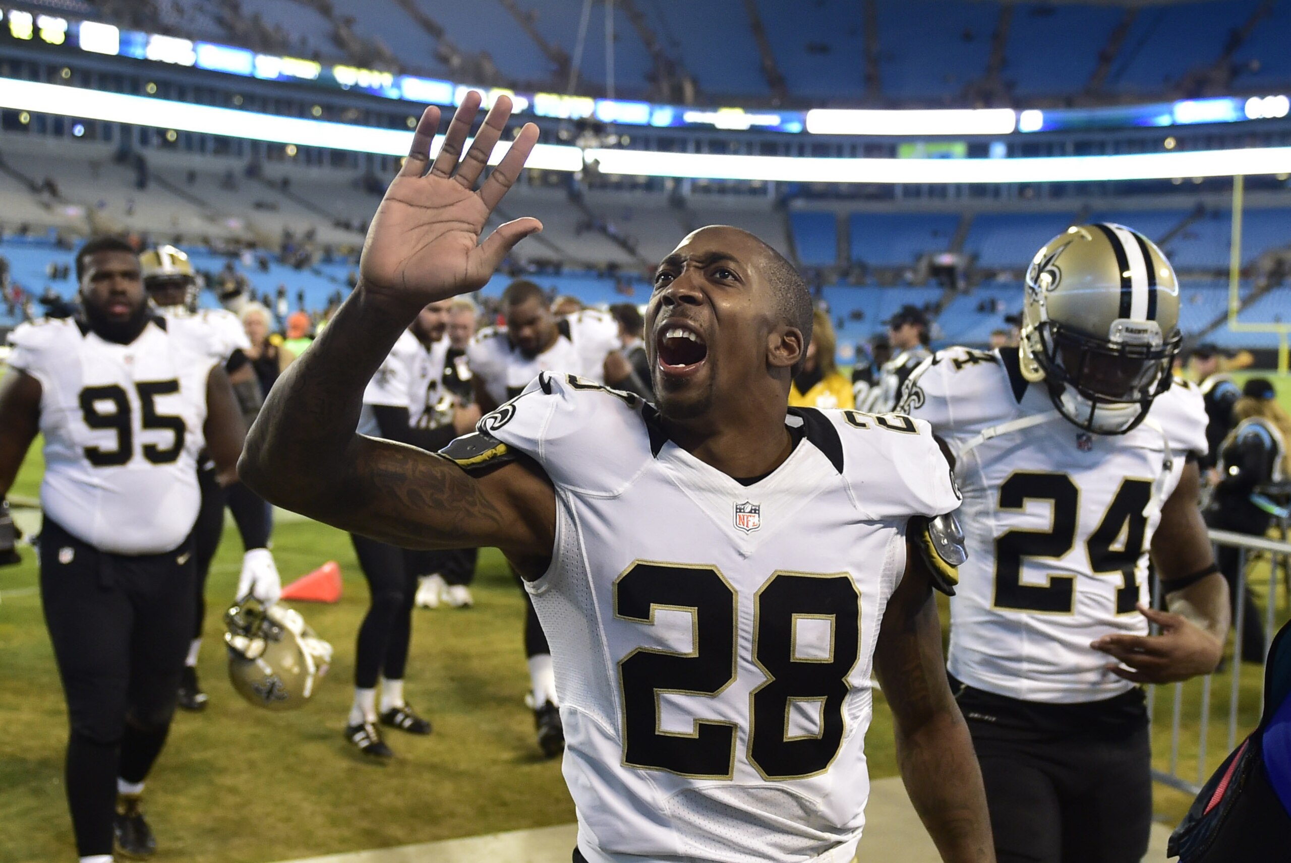 Oct 30, 2014; Charlotte, NC, USA; New Orleans Saints cornerback Keenan Lewis (28) and defensive end Brandon Deaderick (95) and cornerback Corey White (24) leave the field after the game. The Saints defeated the Panthers 28-10 at Bank of America Stadium. Mandatory Credit: Bob Donnan-USA TODAY Sports
