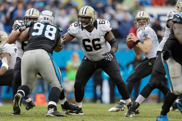 As teammate Brian De La Puente blocks Carolina Panthers' Linden Gaydosh (98), New Orleans Saints' Ben Grubbs (66) looks to help protect quarterback Drew Brees (9) in the pocket during the second half an NFL football game in Charlotte, N.C., Sunday, Dec. 22, 2013. The Panthers won 17-13. (AP Photo/Bob Leverone)